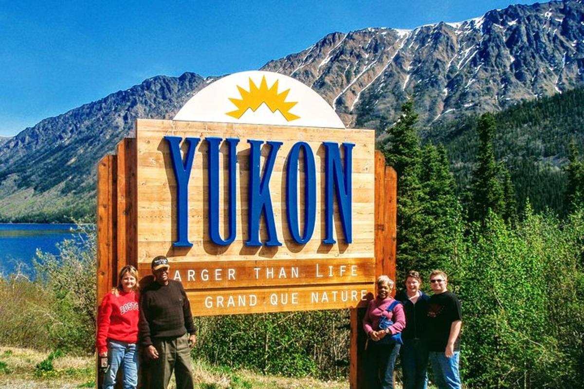 a group of people standing in front of a sign