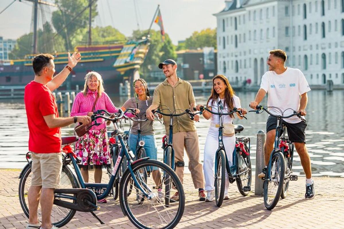 a group of people standing with bikes on a pier