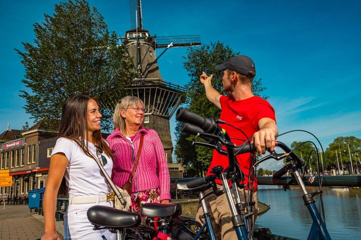 two women and a man standing next to a bike