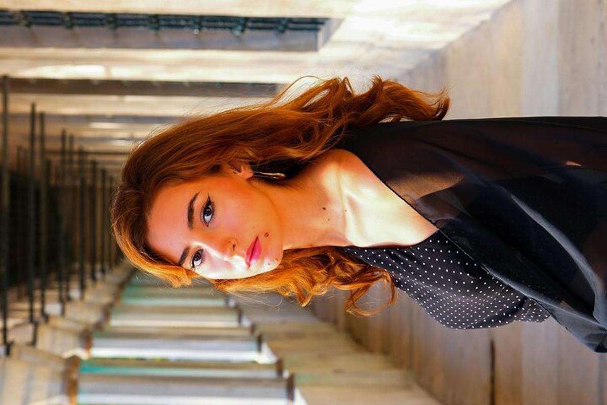 a woman with red hair is standing on stairs