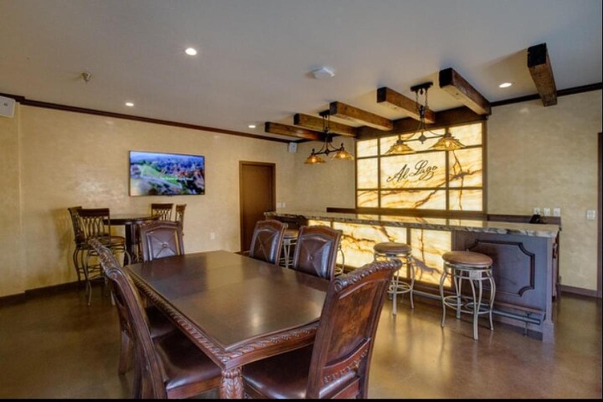 a dining room with a table and chairs and a bar