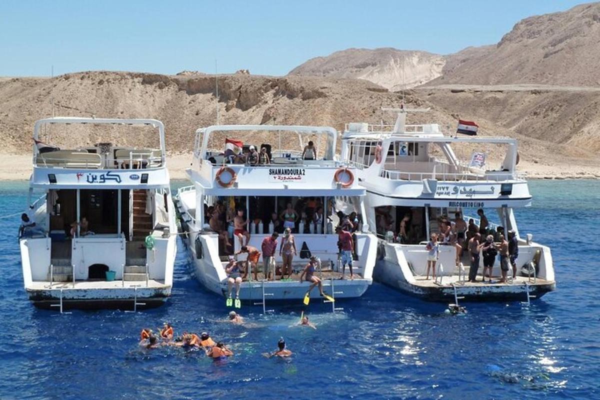 three boats in the water with people on them