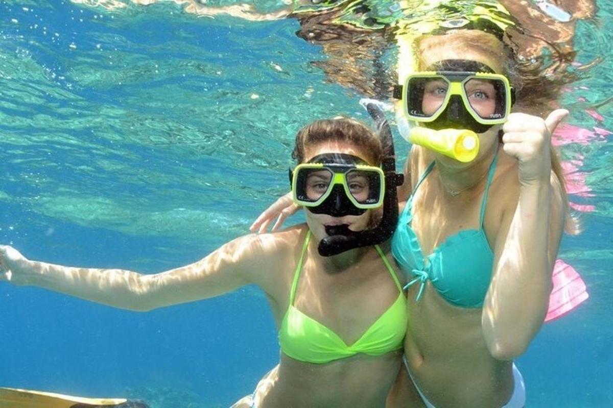 two women in the water wearing diving masks