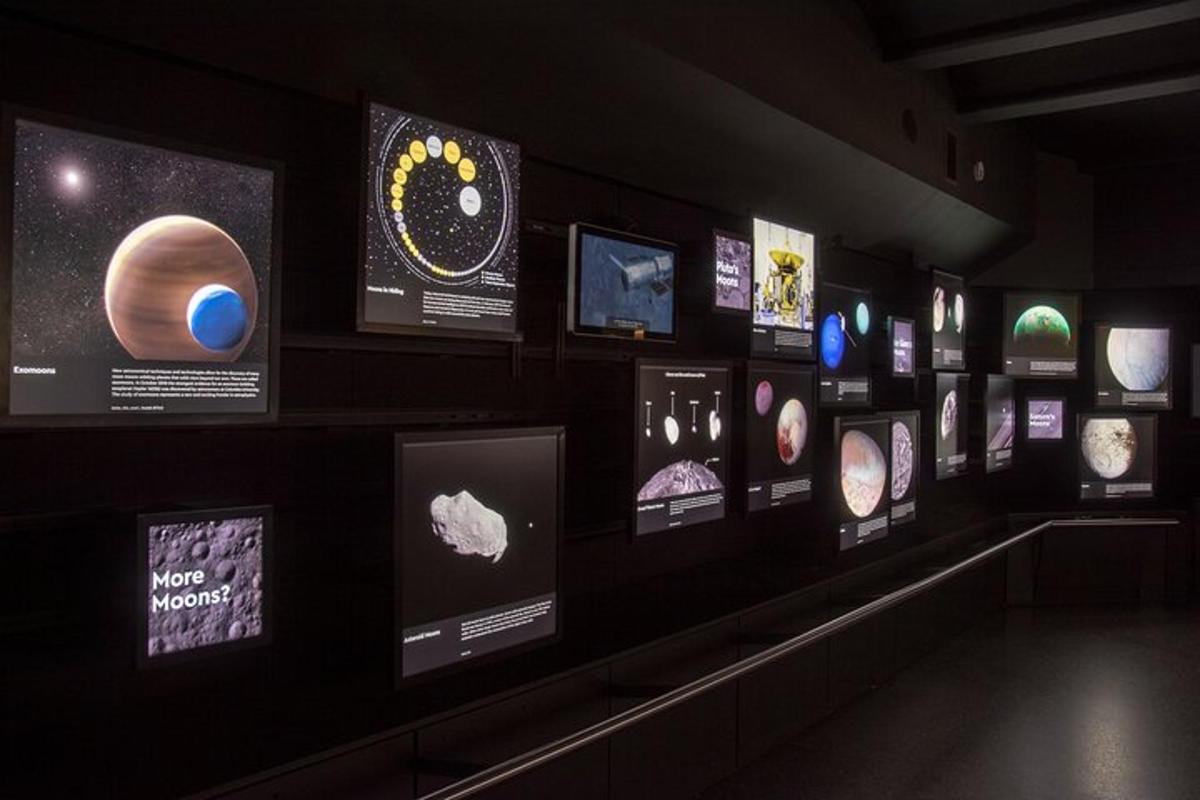 a room with planets and pictures on a wall