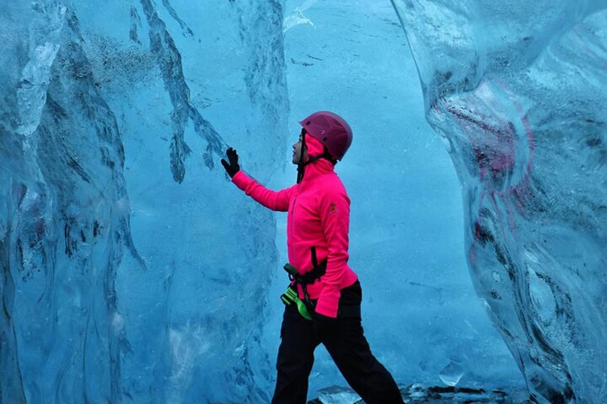 a person is standing in front of an ice wall