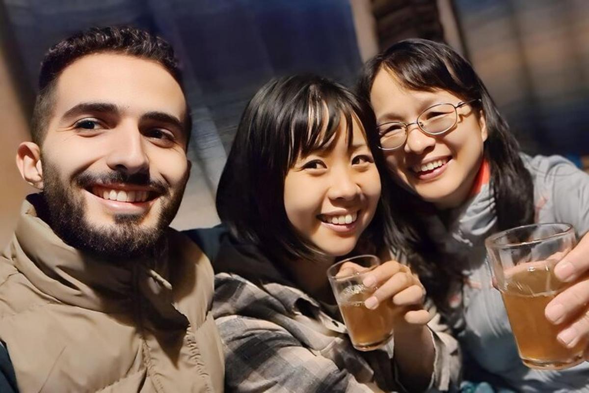 a group of three people holding glasses of beer