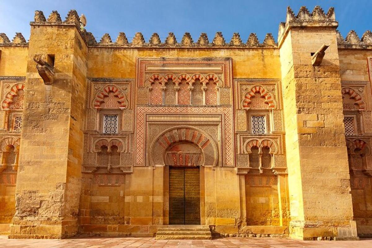 an old building with a gate and an arch way