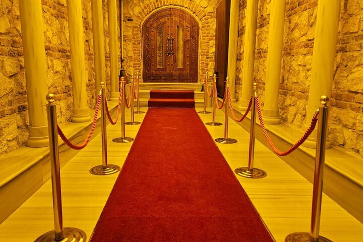 a red carpeted corridor with a long red carpet