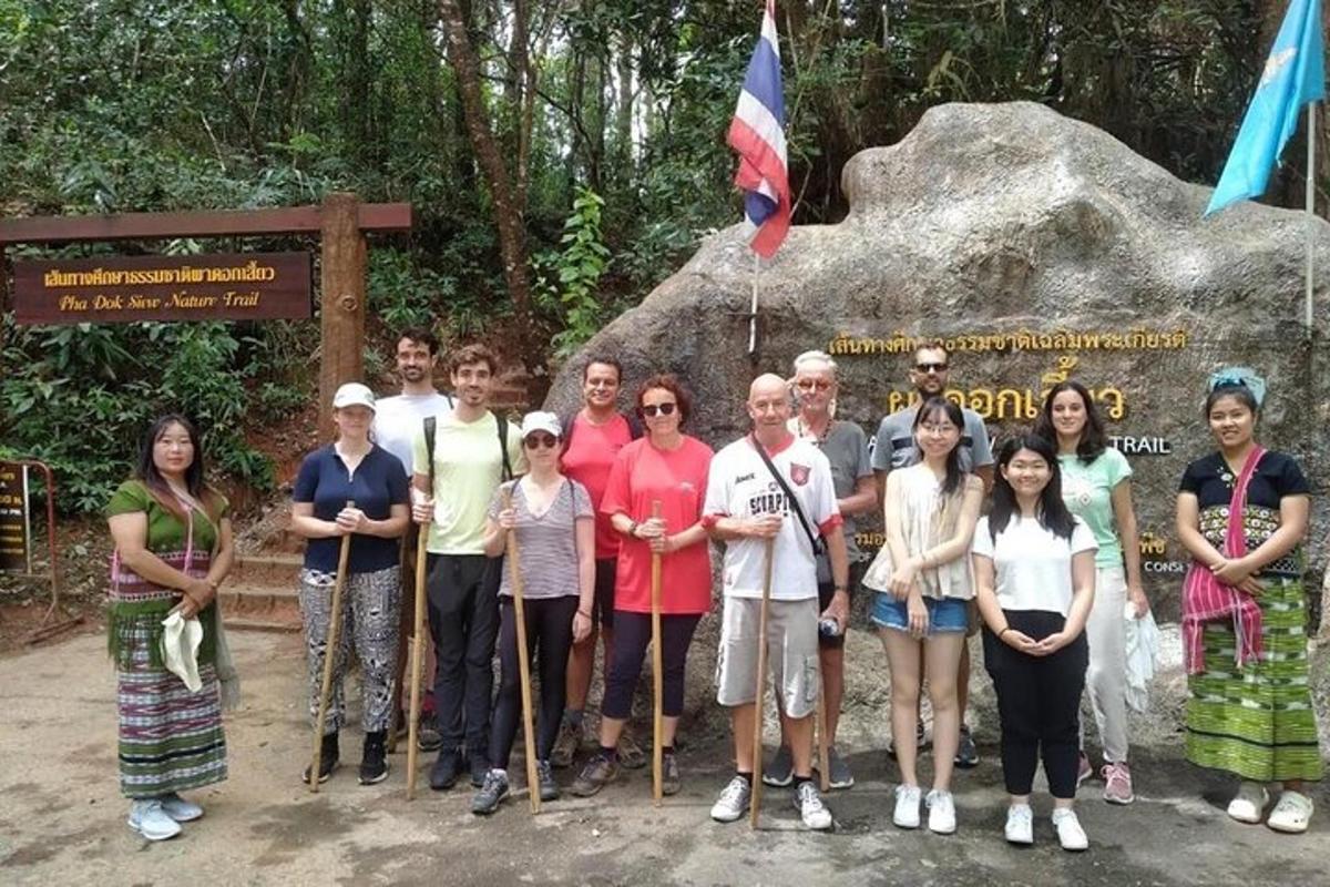 a group of people standing in front of a sign