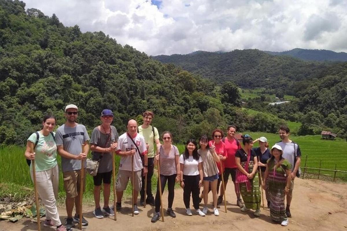 a group of people posing for a picture on a mountain