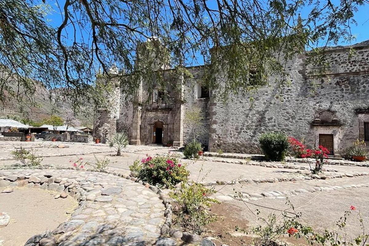 an old stone building with a stone path in front