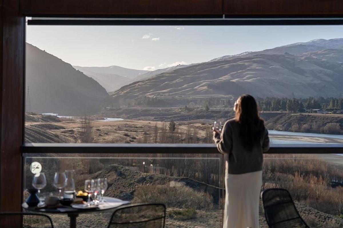 a woman standing in front of a window with a view