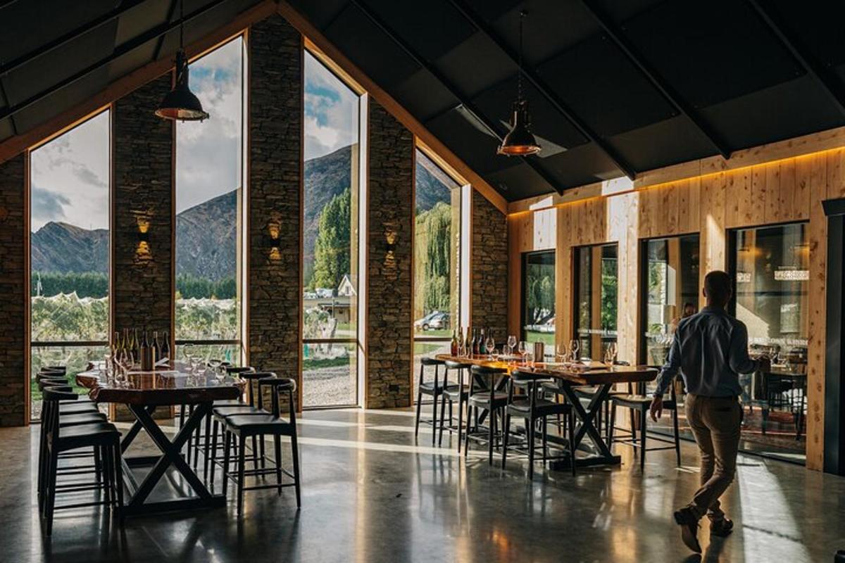 a man walking through a restaurant with tables and chairs