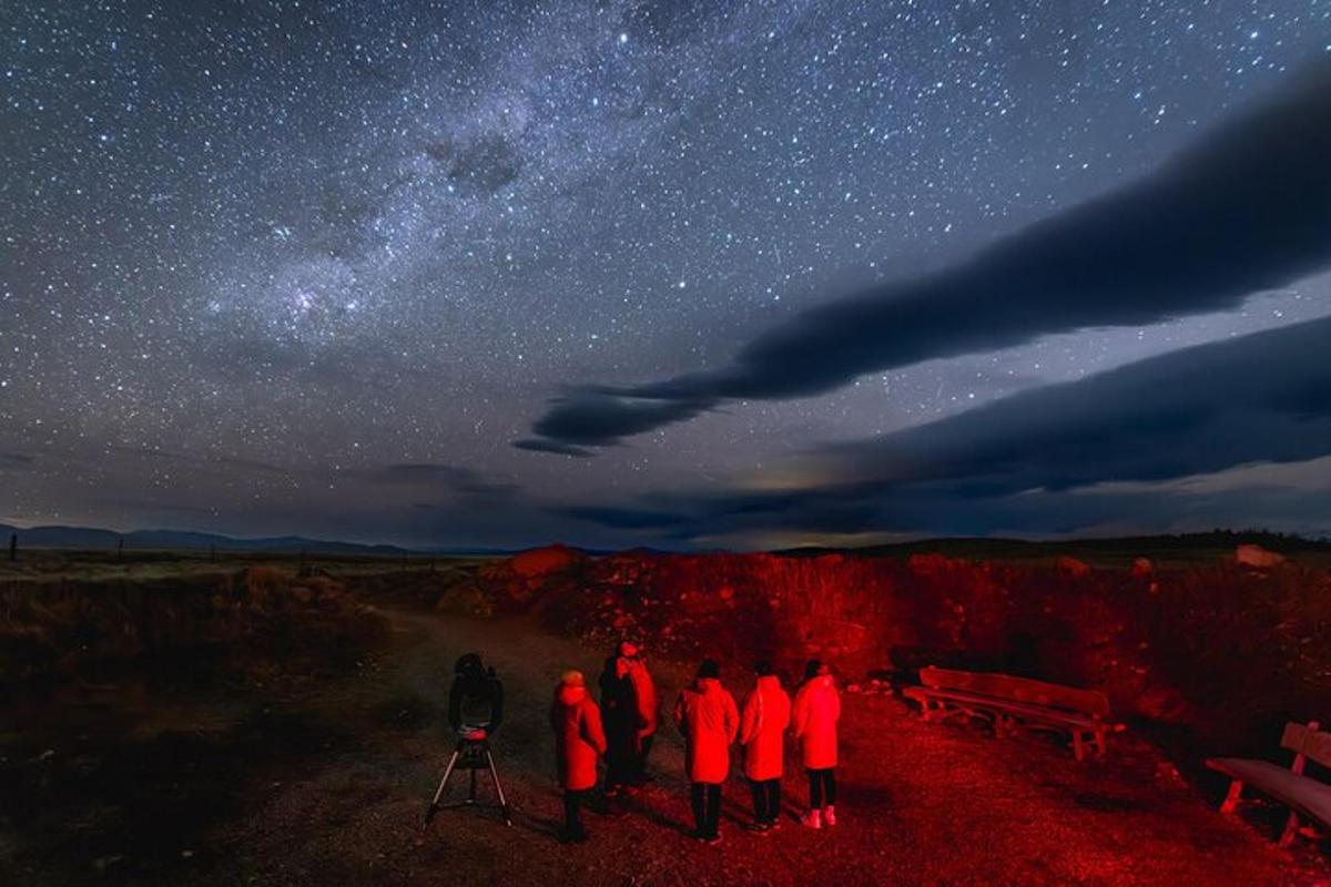 a group of people standing under a starry sky