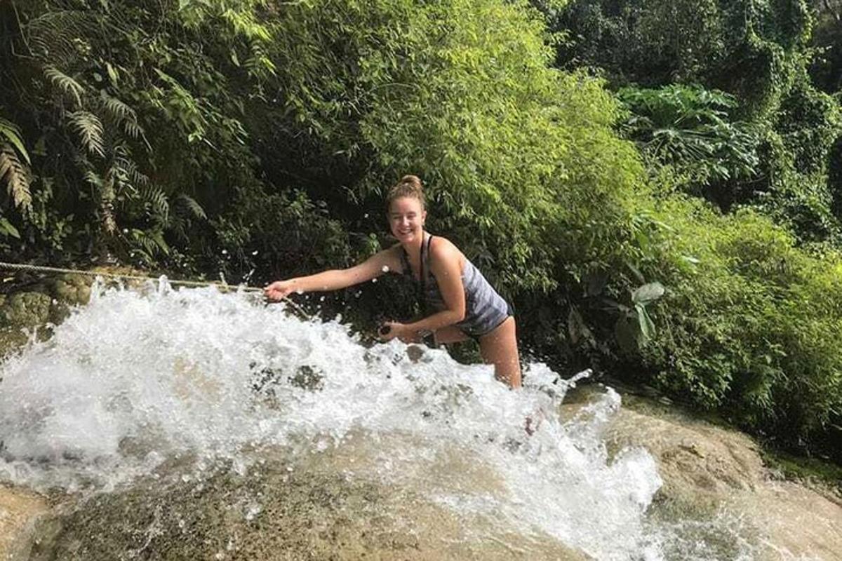 a woman is standing in the water in a river