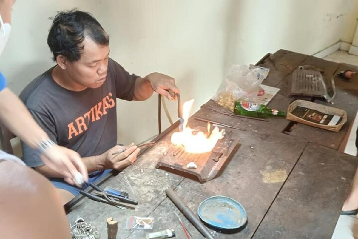 a man is working on a table with fire