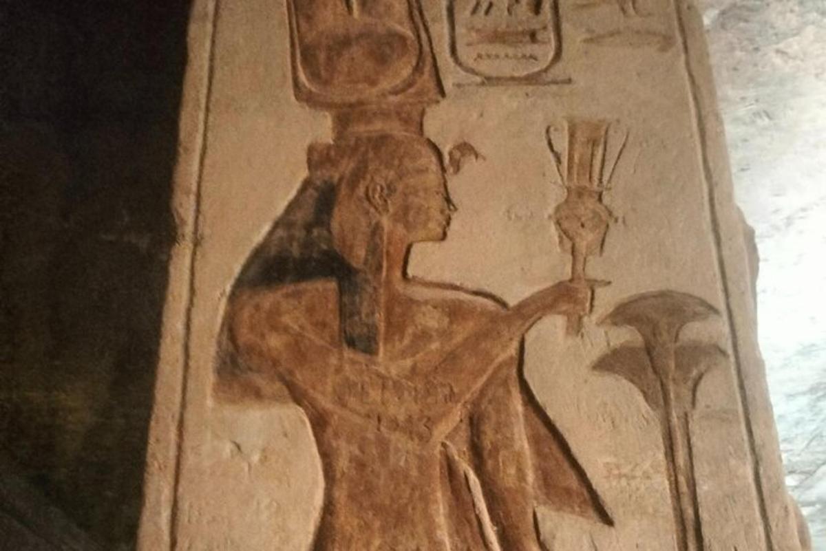 a painting of a woman holding a candle on a wall