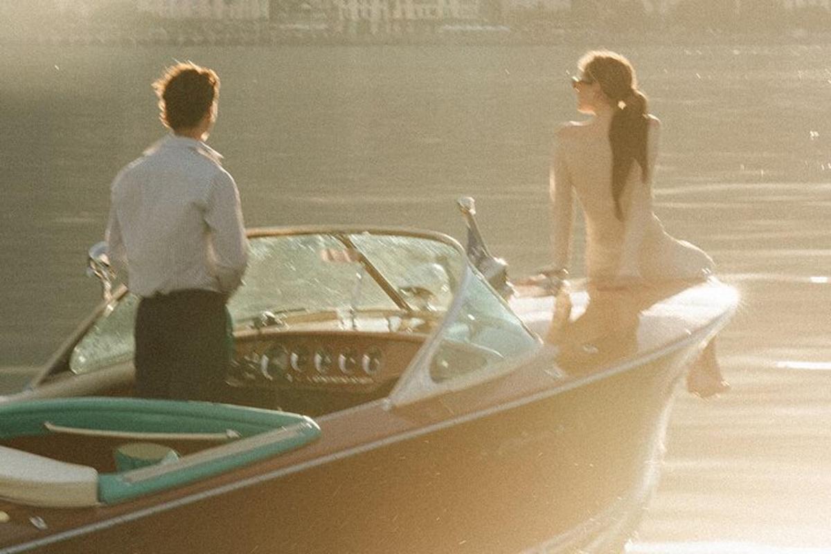a man and a woman in a boat on the water