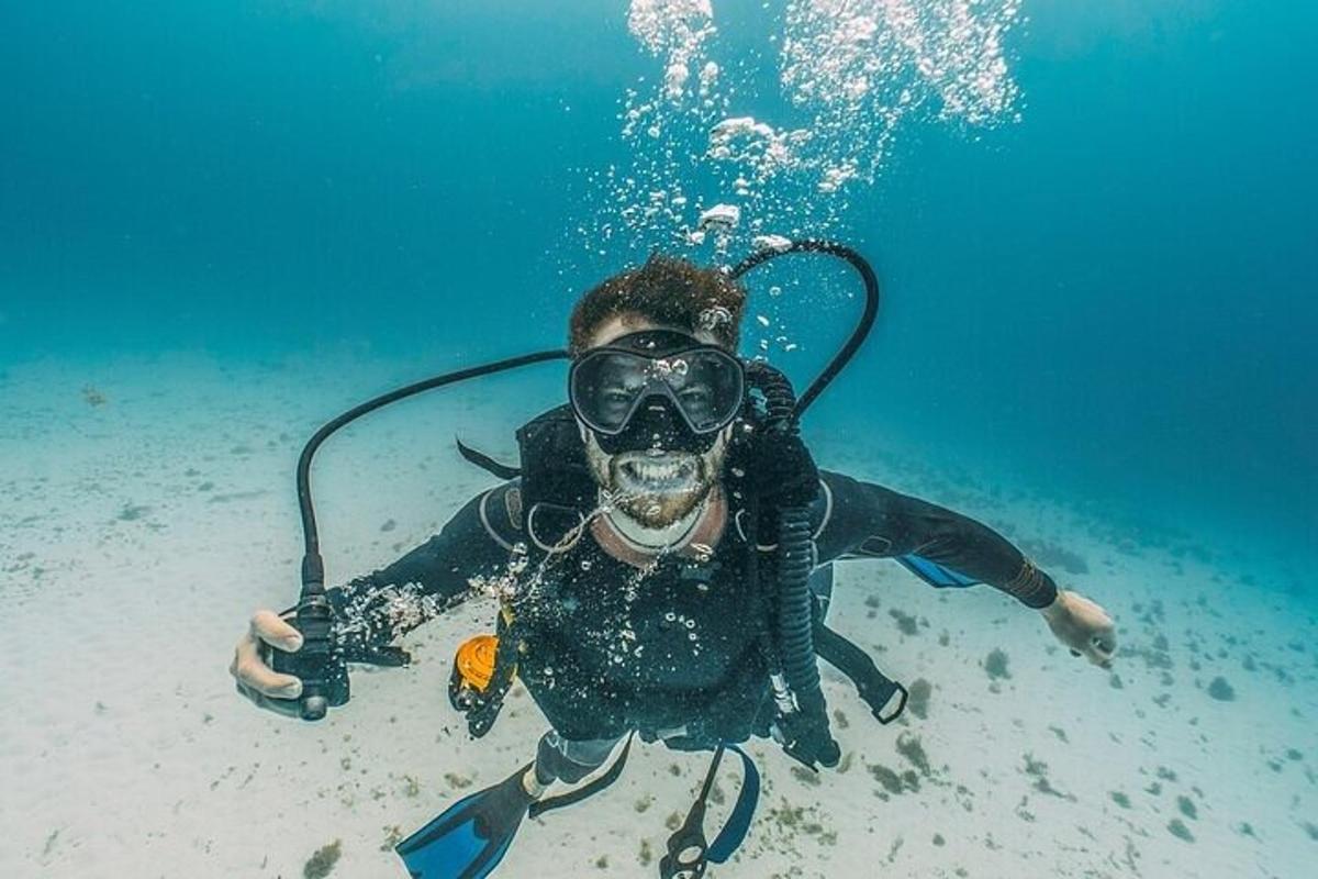 a person in a diver suit and goggles in the water