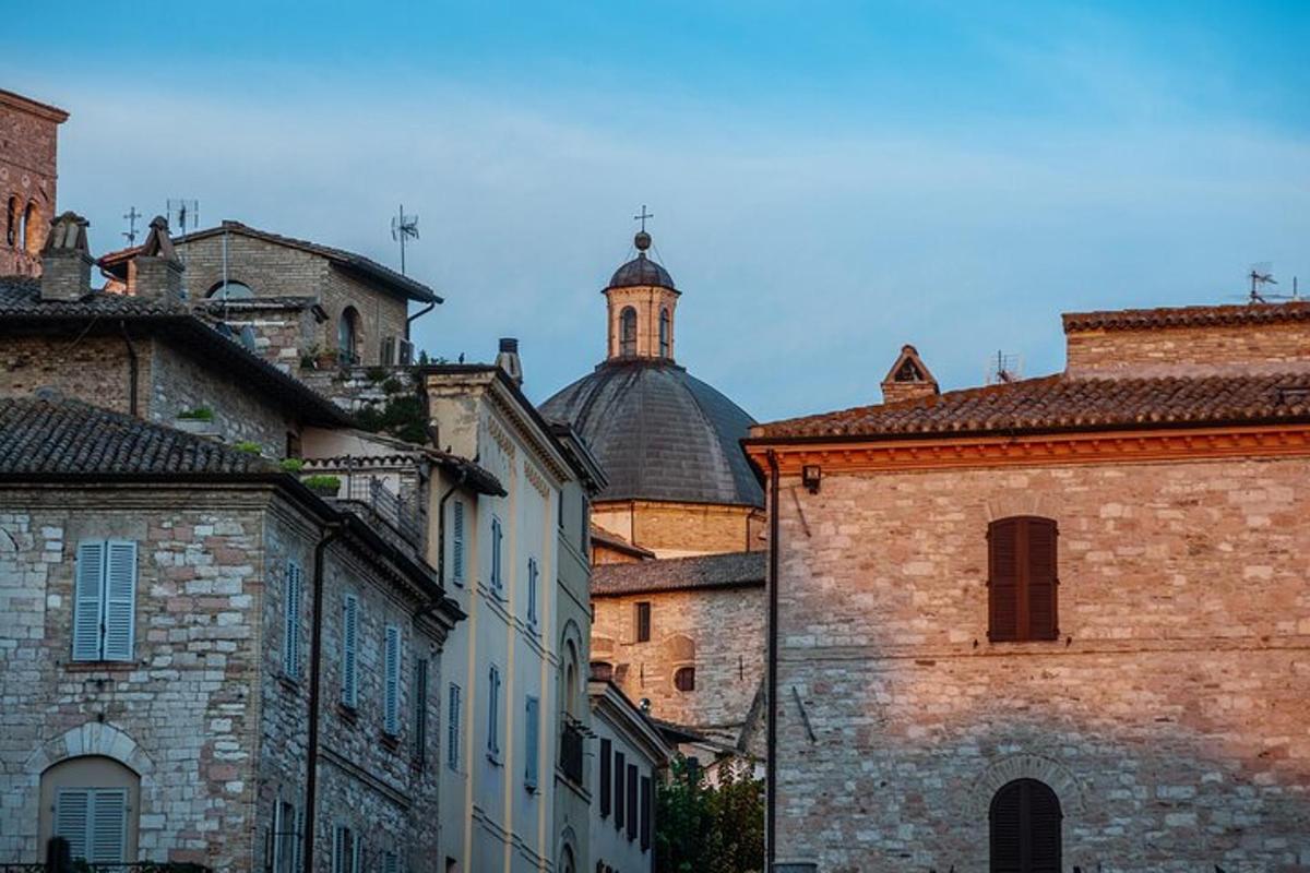 a group of buildings with a dome in the background