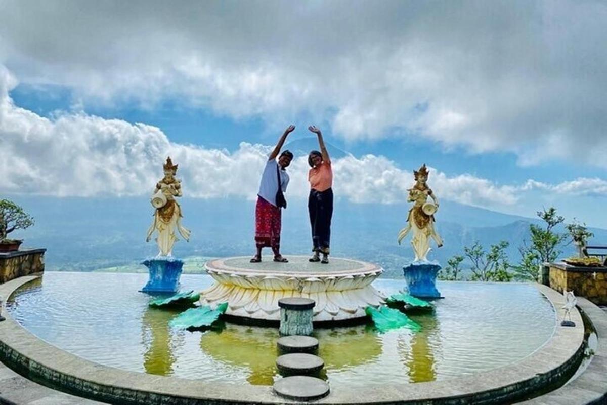 two people standing on top of a fountain