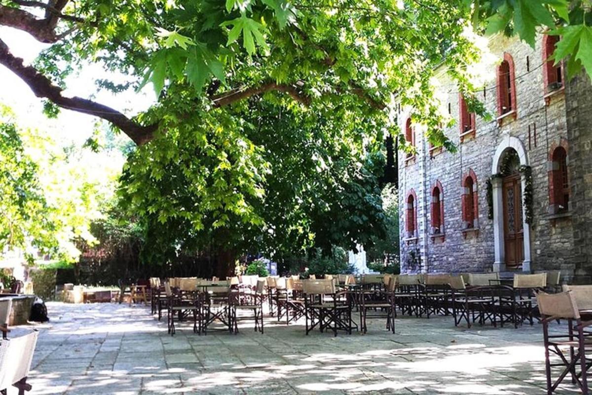 a group of tables and chairs in front of a building