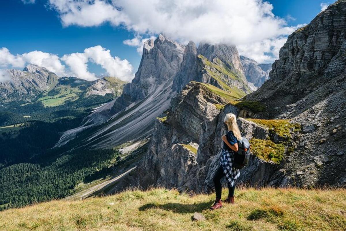 a woman standing on top of a mountain