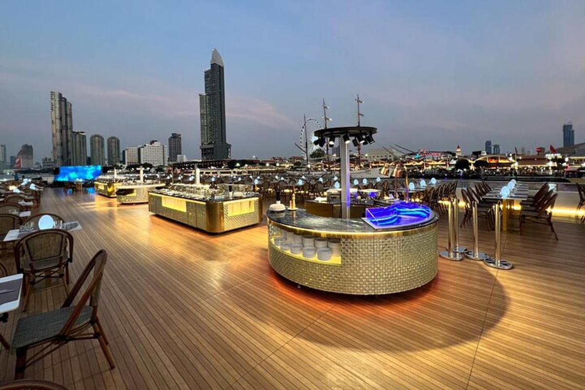 a rooftop deck with tables and chairs on a ship