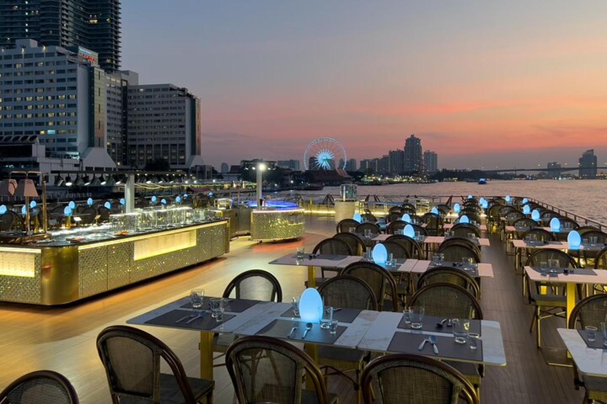 a row of tables and chairs on a deck with a river