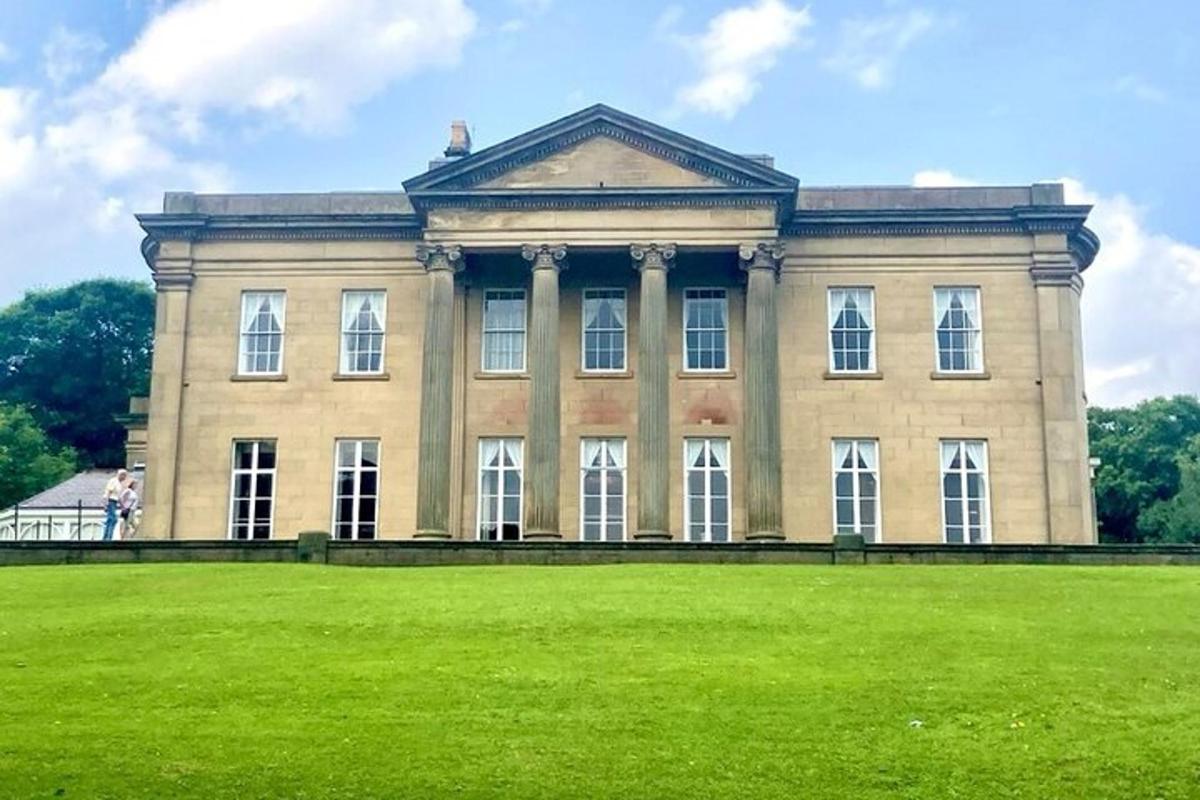 a large building with a grass field in front of it