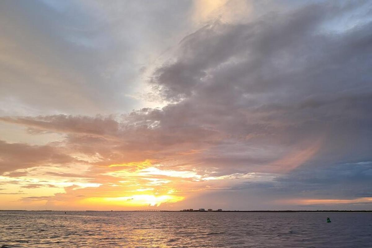a sunset over a body of water with the sun setting