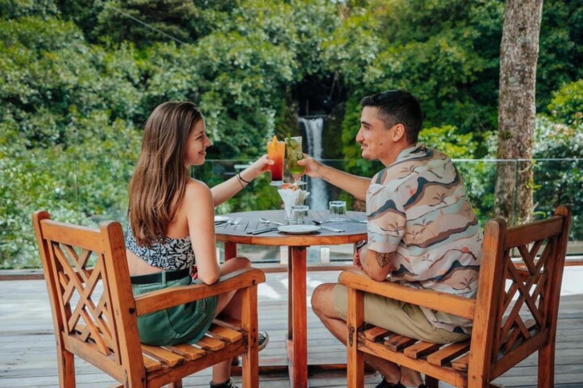 a man and woman sitting at a table drinking juice