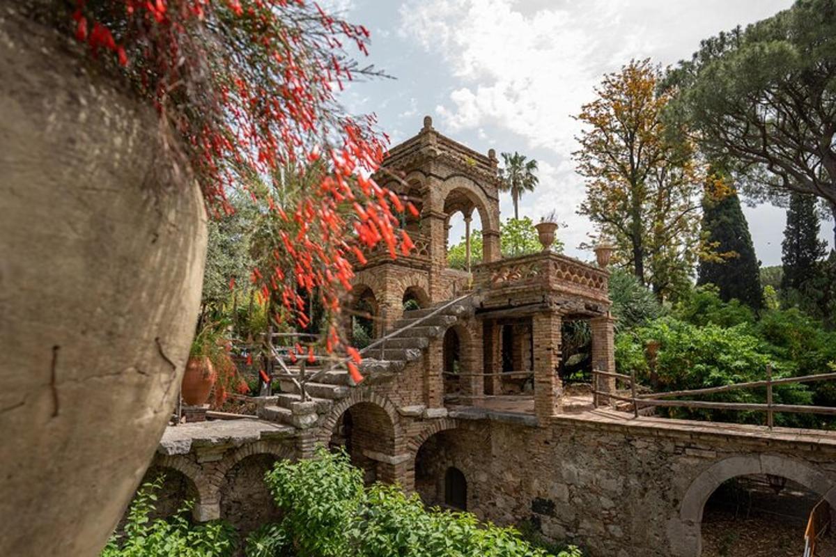 an old stone building with stairs and a bridge