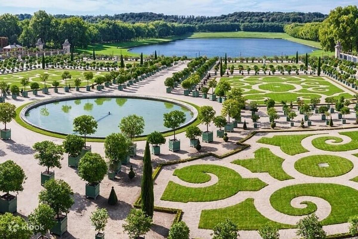 an aerial view of a garden with a pond
