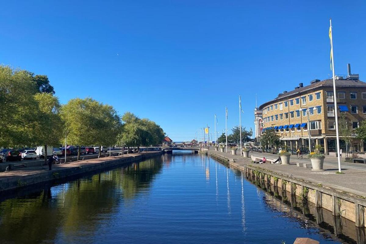 a river in a city with cars parked on the side