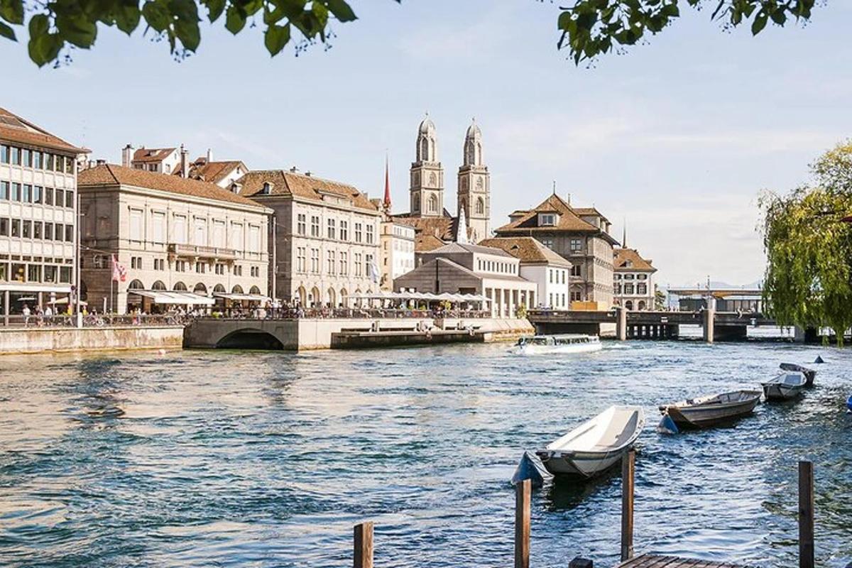 a river with boats in a city with buildings