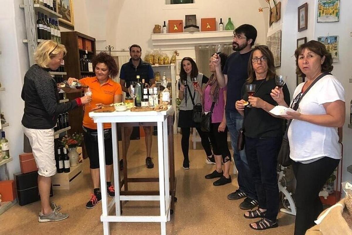 een groep mensen die in een kamer staan met wijnflessen