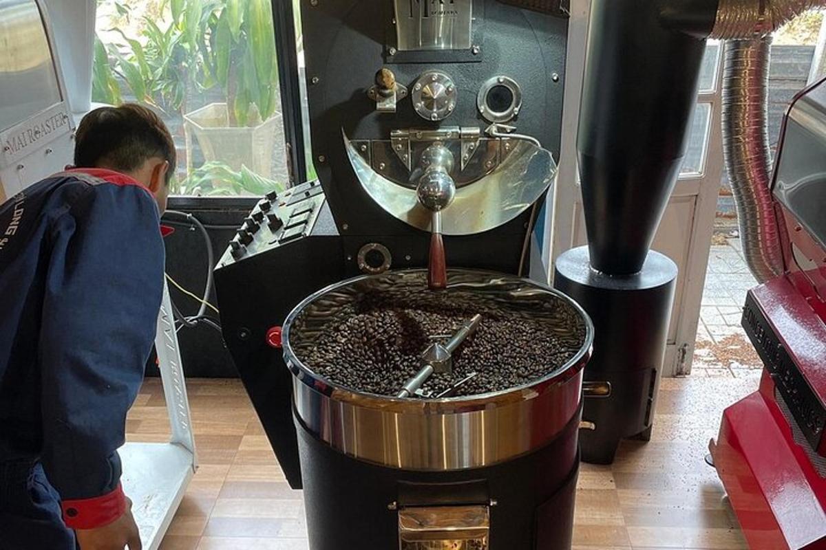 a man standing next to a coffee making machine