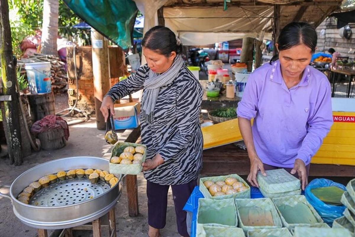two women are standing in a market with food