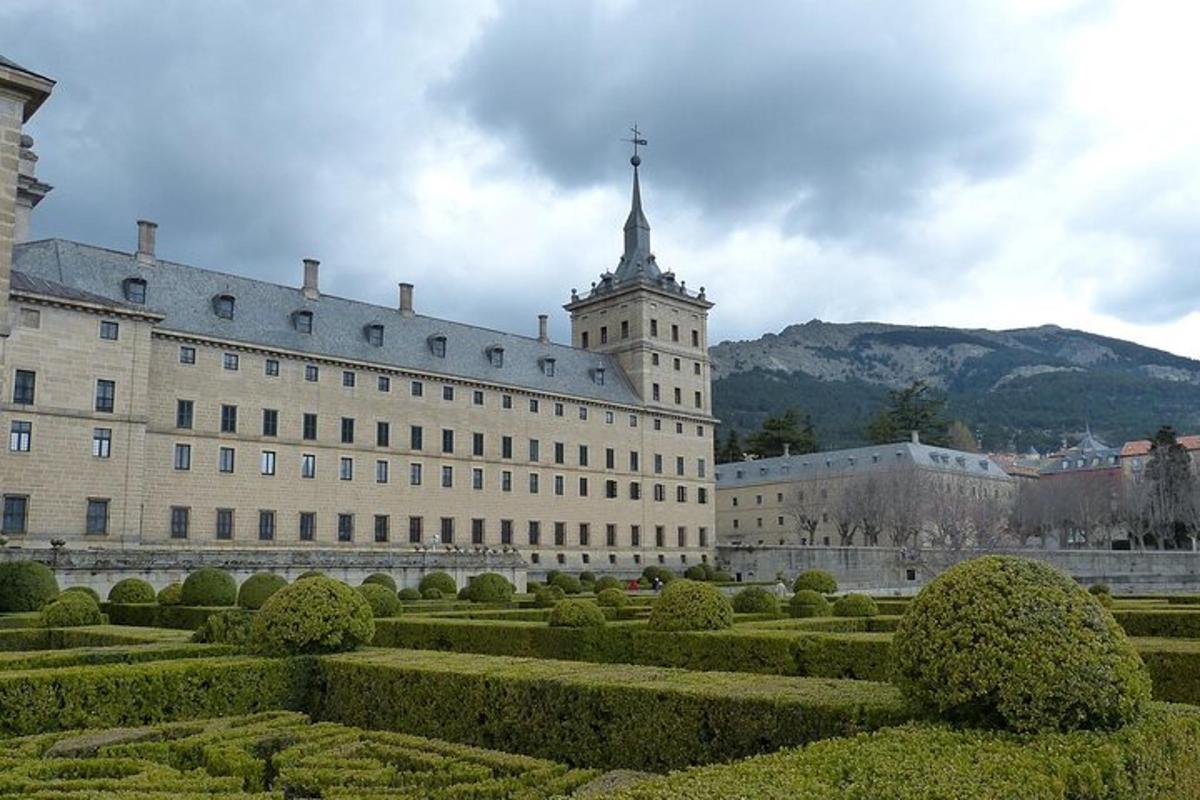 a large building with a clock tower and a garden