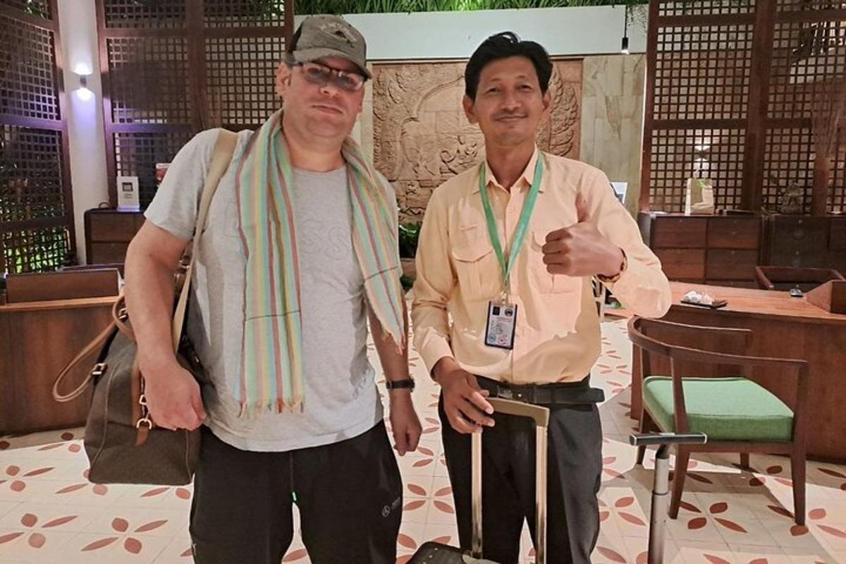 two men standing next to each other in a room