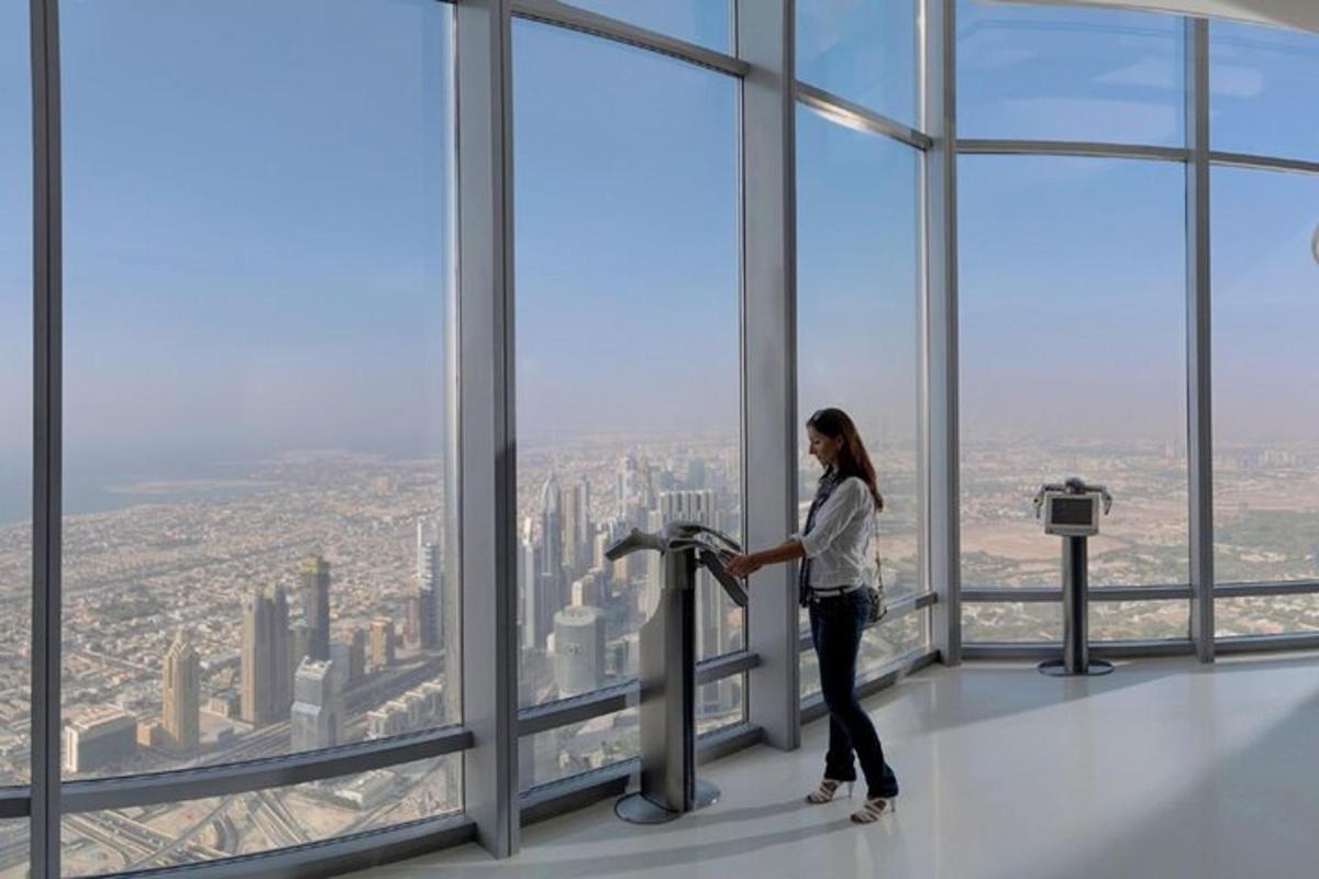 a woman standing in a room in the top of a building