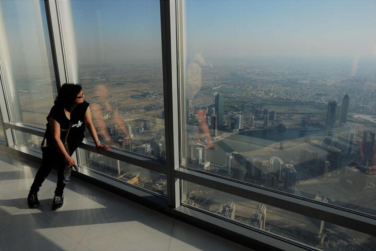 a woman looking out the window of a skyscraper