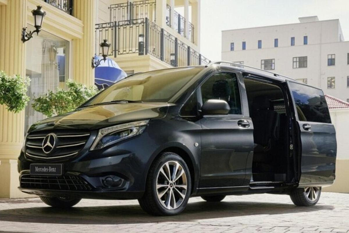 a black mercedes benz minivan parked on a street