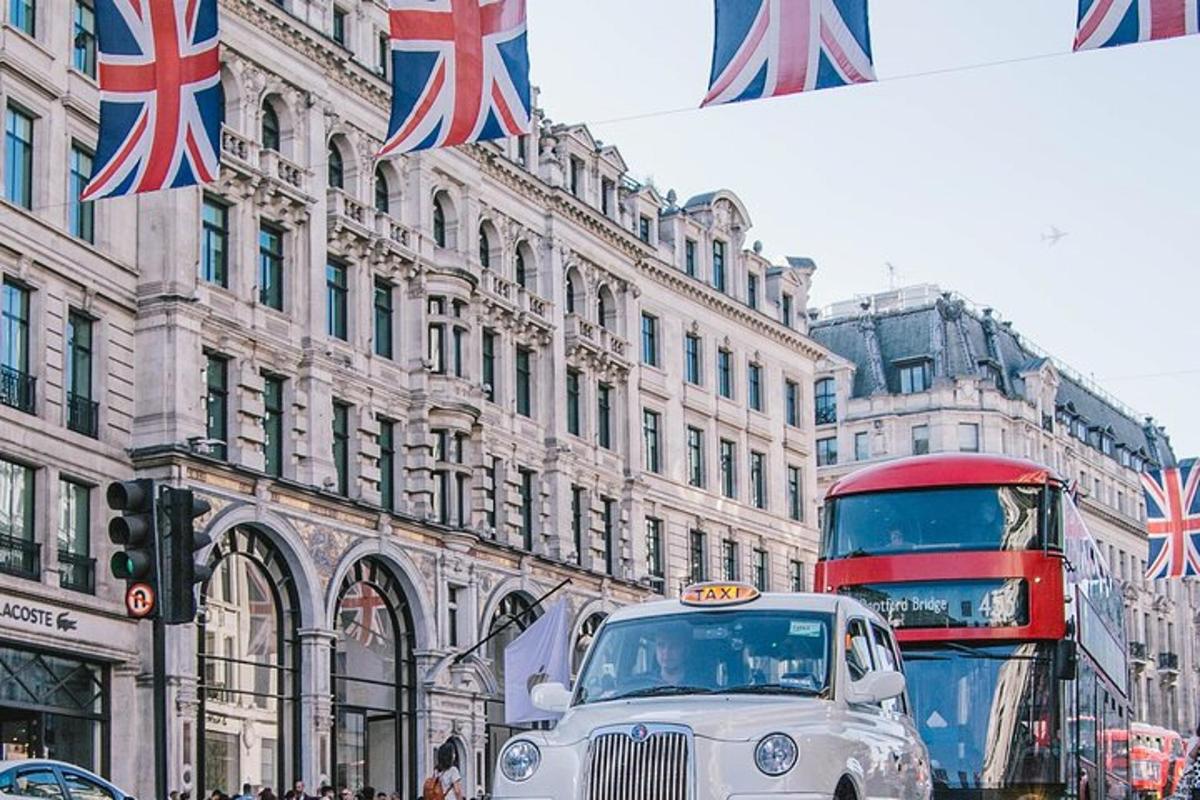 an old car driving down a street with a double decker bus