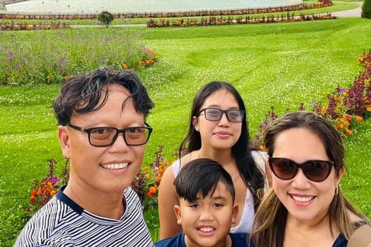 Una familia posando para una foto en un parque