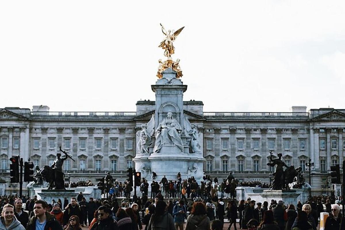 a crowd of people standing in front of a large building