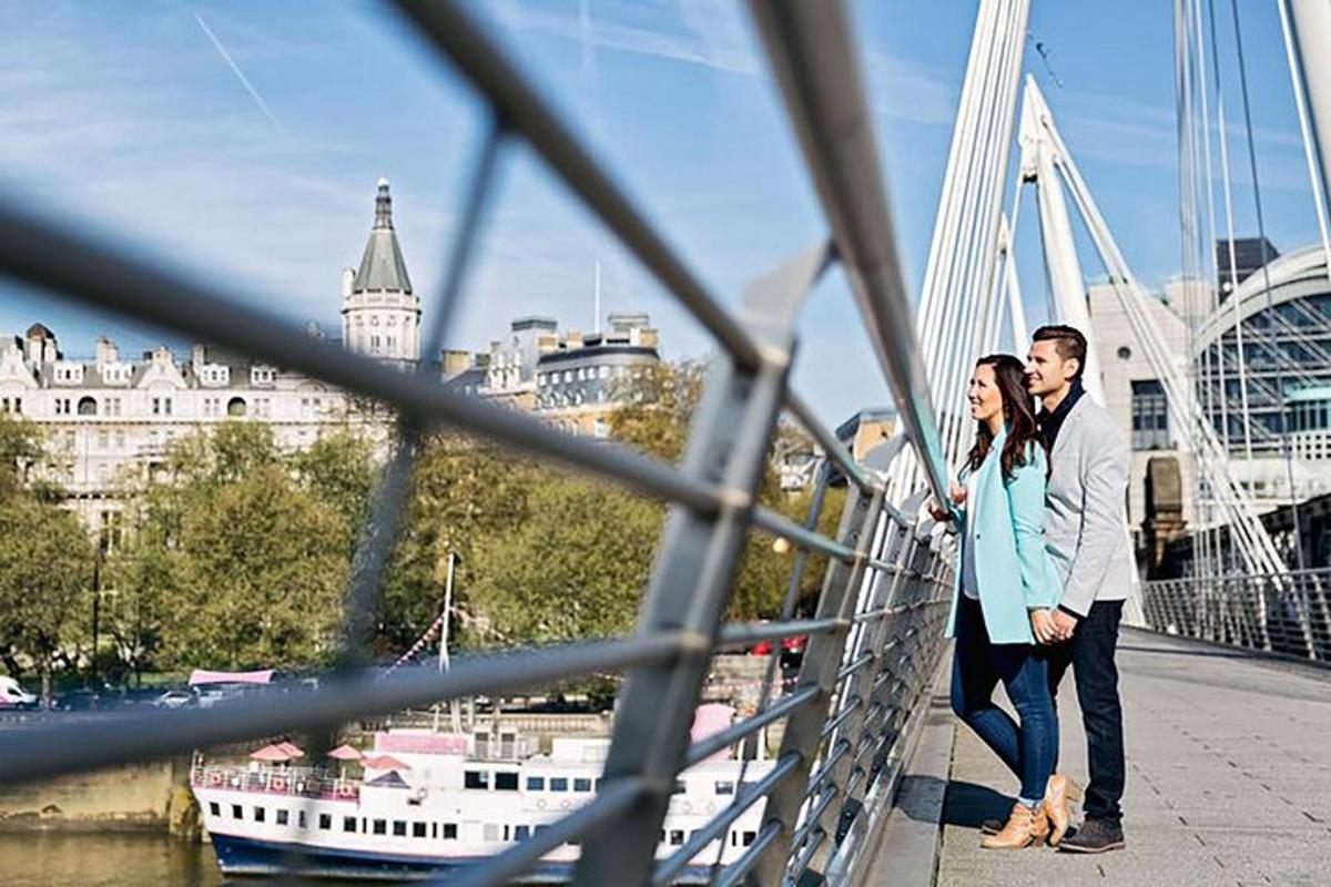 a man and a woman standing on a bridge