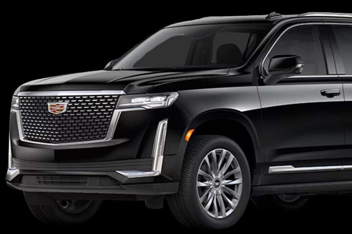Ένα μαύρο αυτοκίνητο Cadillac Escalade σε μαύρο φόντο