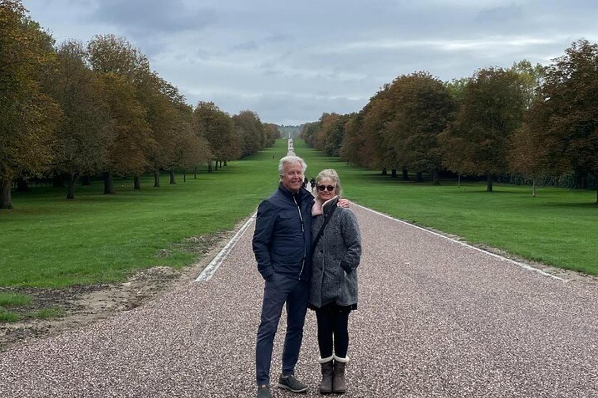 a man and woman standing in the middle of a road